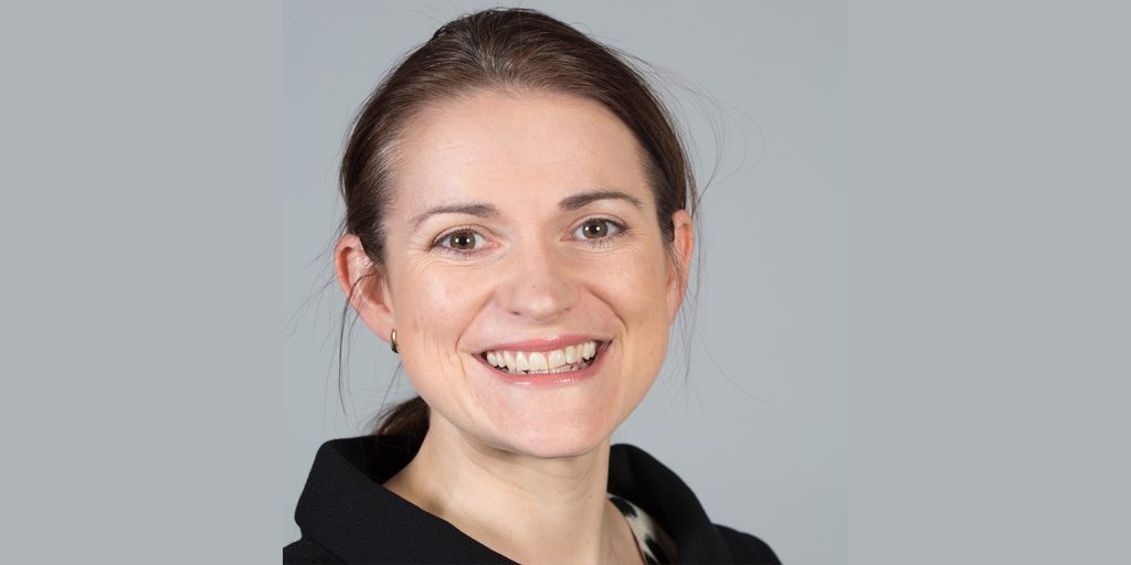 Headshot of Catherine Stihler, smiling and wearing a black top.